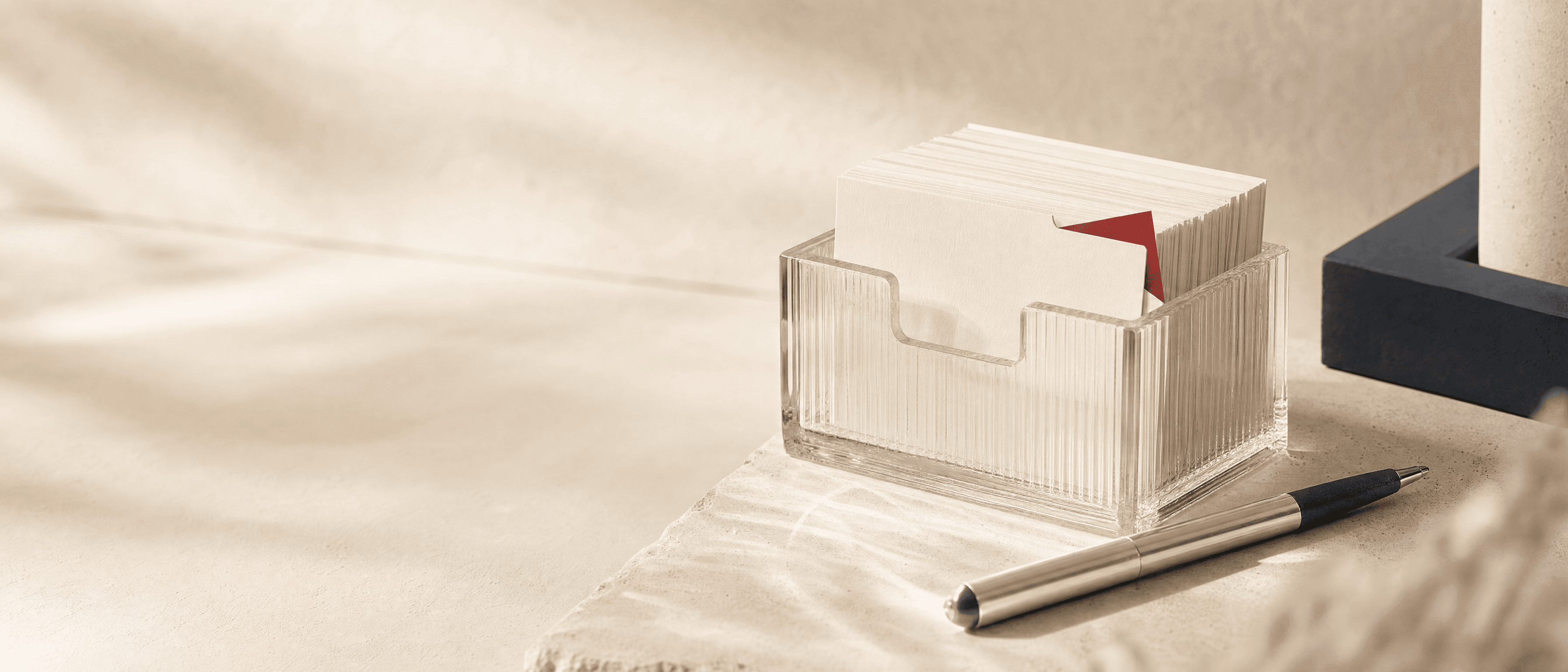 An ivory answer archive held in ribbed glass with a single carmine index tab.