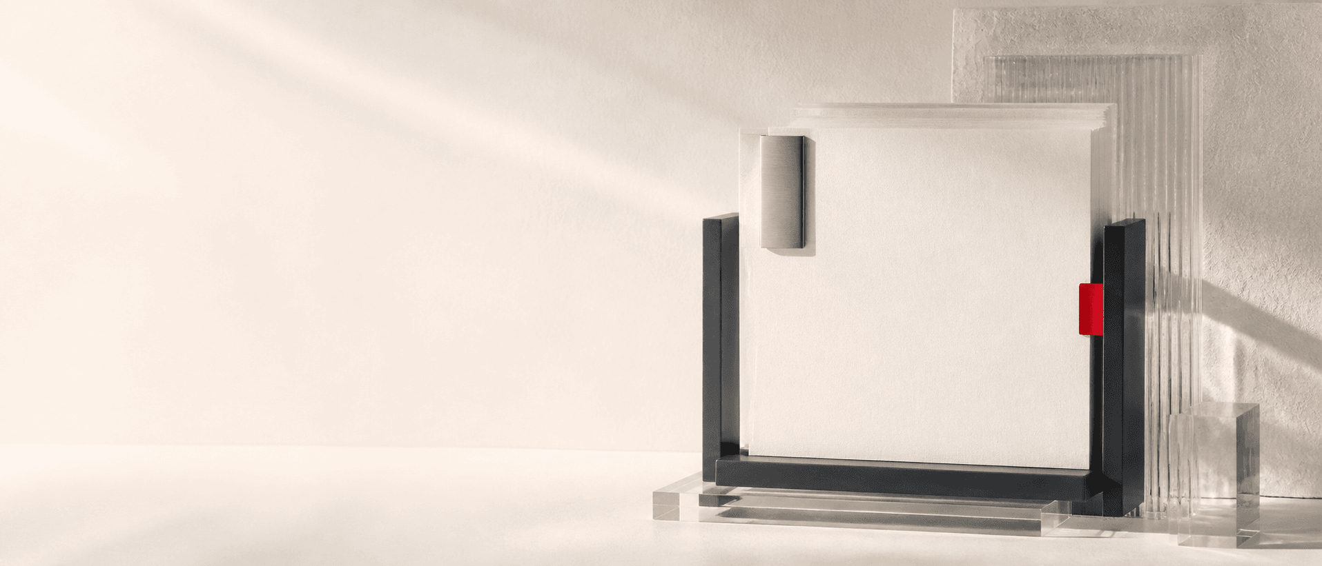 Blank papers held in a graphite frame with a metal clip and red index tab