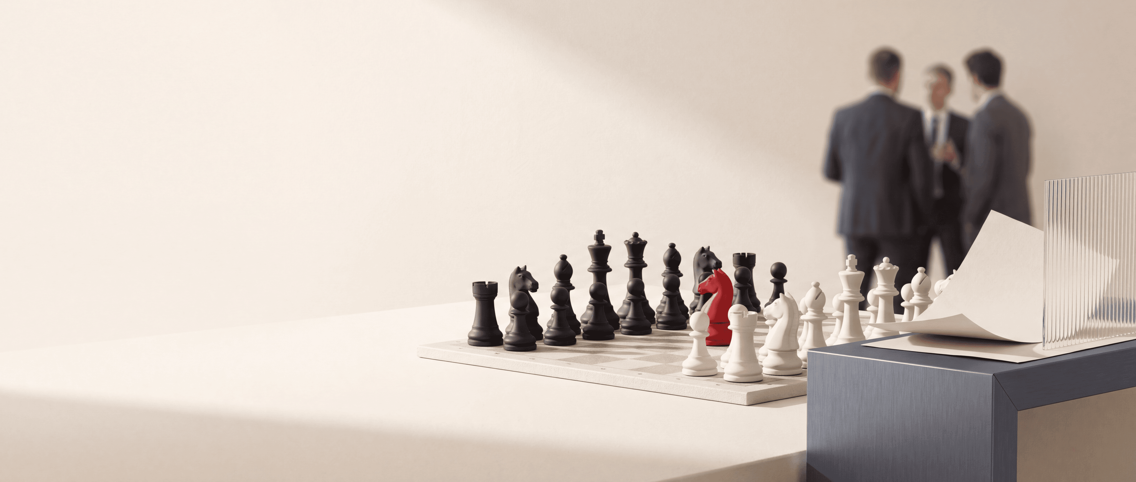 A chessboard with one carmine knight, ivory papers, ribbed glass, and a graphite architectural table.
